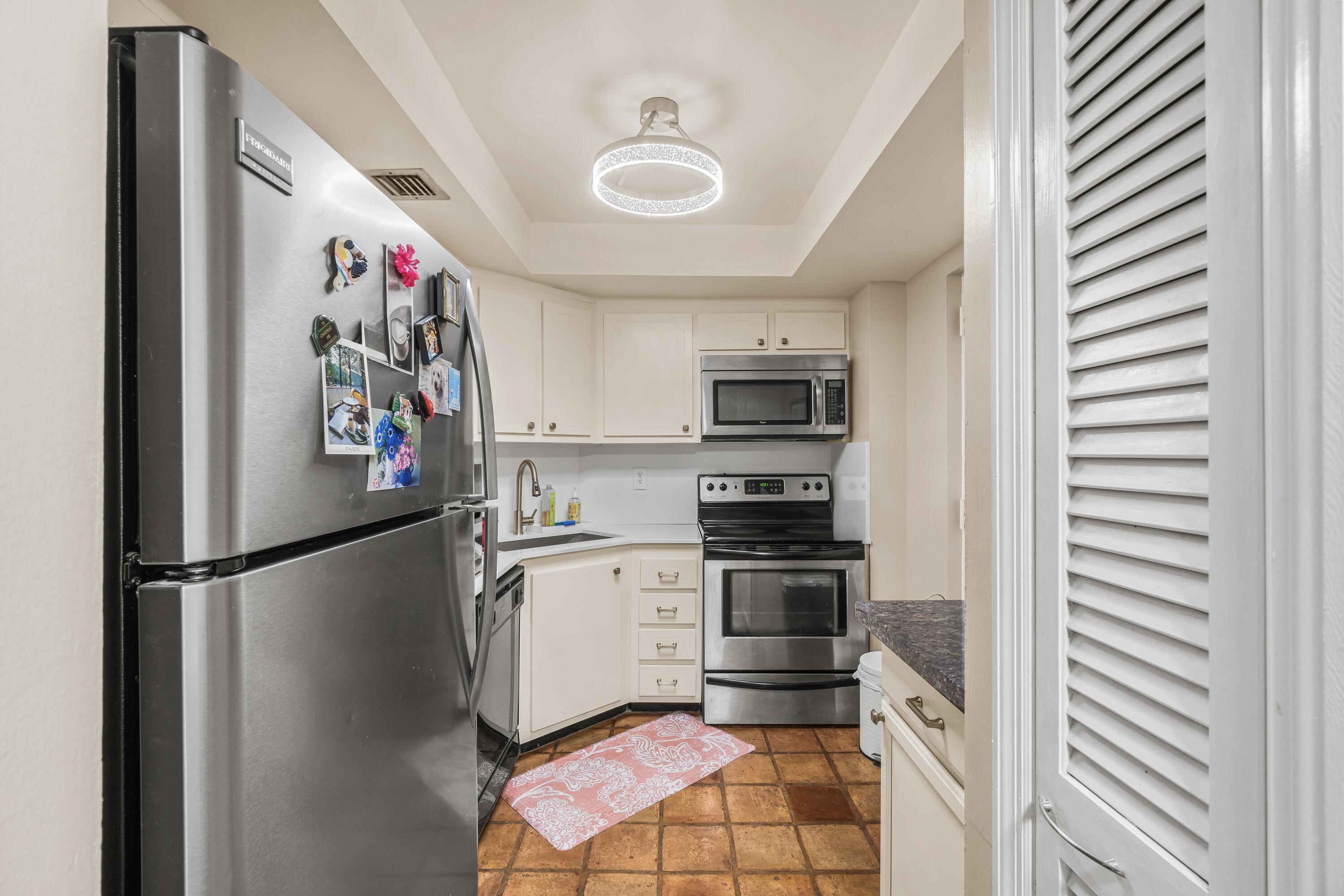 290 West Palmetto Park Road, Unit 114 Boca Raton, FL 33432 - Photo 6 of 25 a kitchen with stainless steel appliances granite countertop a refrigerator and a stove top oven