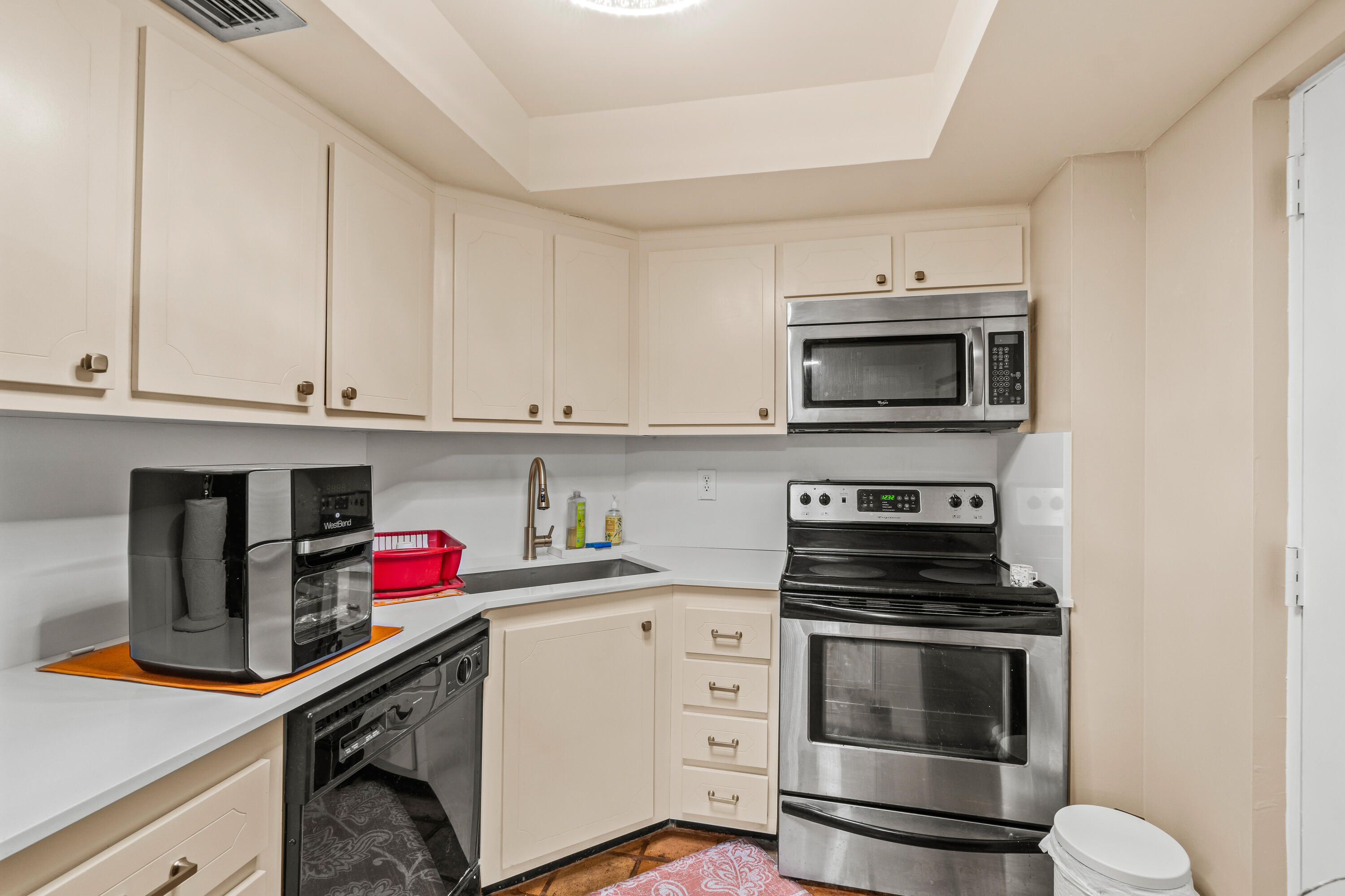 290 West Palmetto Park Road, Unit 114 Boca Raton, FL 33432 - Photo 8 of 25 a kitchen with appliances a sink and cabinets