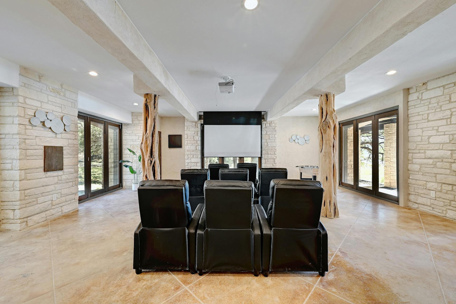 6021 Circle J Road Marble Falls, TX 78654 - Photo 29 of 39 Cinema with french doors and healthy amount of natural light