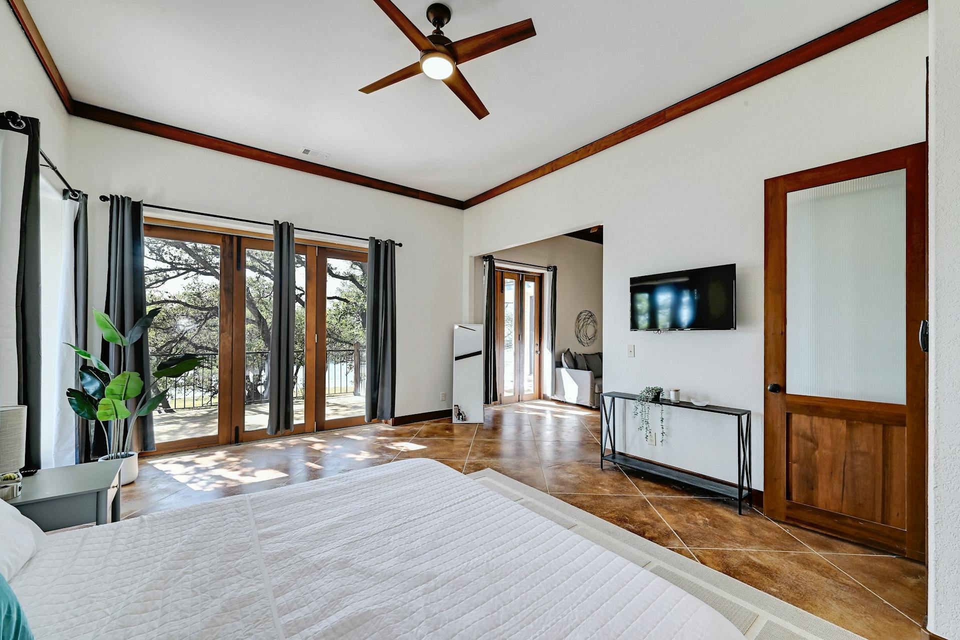 6021 Circle J Road Marble Falls, TX 78654 - Photo 34 of 39 Tiled bedroom with a ceiling fan, access to outside, and ornamental molding
