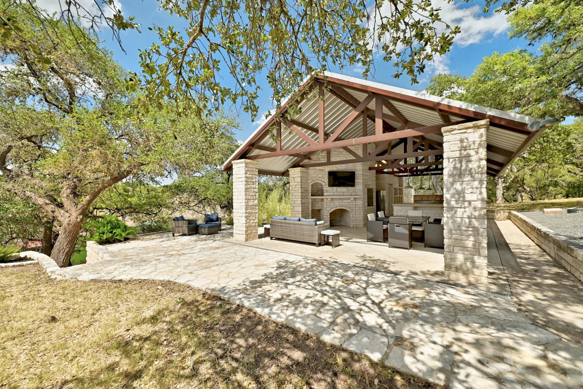6021 Circle J Road Marble Falls, TX 78654 - Photo 7 of 39 View of patio featuring an outdoor brick fireplace and an outdoor kitchen with living area