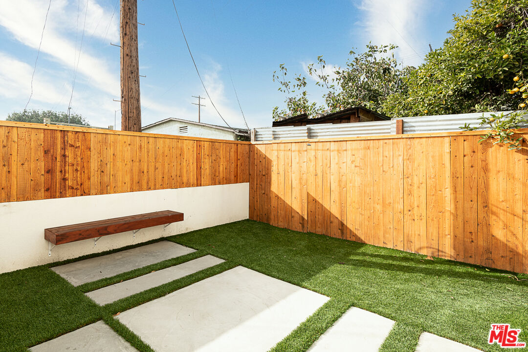 5464 Geer Street Los Angeles, CA 90016 - Photo 19 of 21 a view of a backyard with a bench
