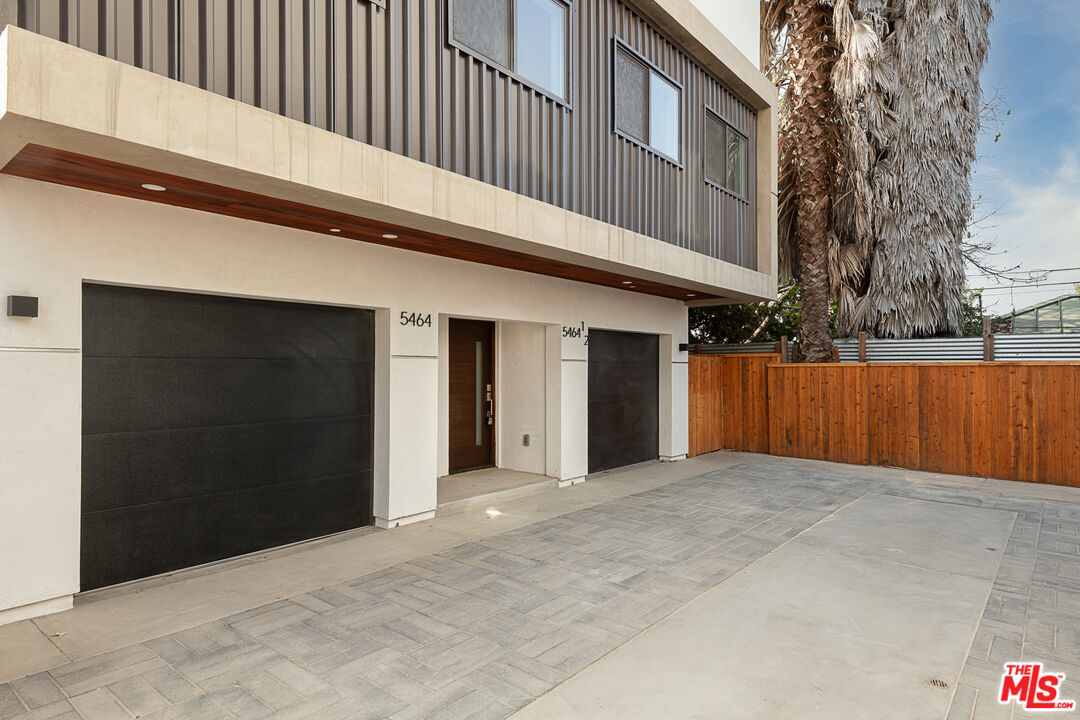 5464 Geer Street Los Angeles, CA 90016 - Photo 20 of 21 a view of a house with a wooden fence
