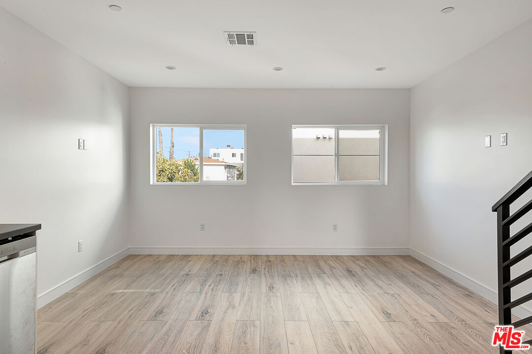 5464 Geer Street Los Angeles, CA 90016 - Photo 8 of 21 wooden floor in an empty room with a window