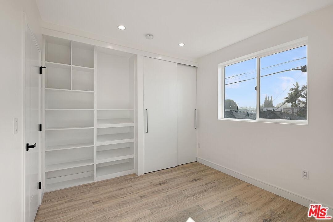 5464 Geer Street Los Angeles, CA 90016 - Photo 9 of 21 a view of an empty room with a window and wooden floor