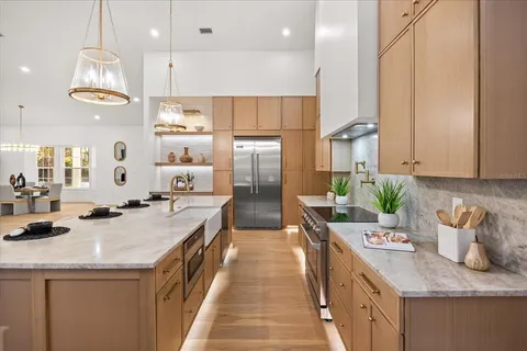 a spacious bedroom with a bed and a chandelier