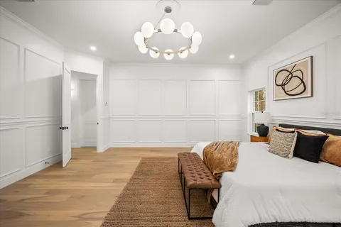 a living room with furniture a window and wooden floor