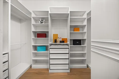 a living room with furniture a fireplace and a potted plant
