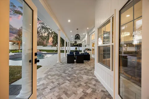 a living room with couches and a dining table with a large window