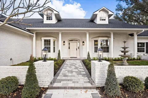 a living room with fireplace furniture and a large window