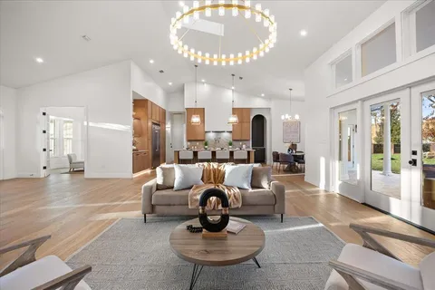 a kitchen with stainless steel appliances granite countertop a sink a stove and a refrigerator