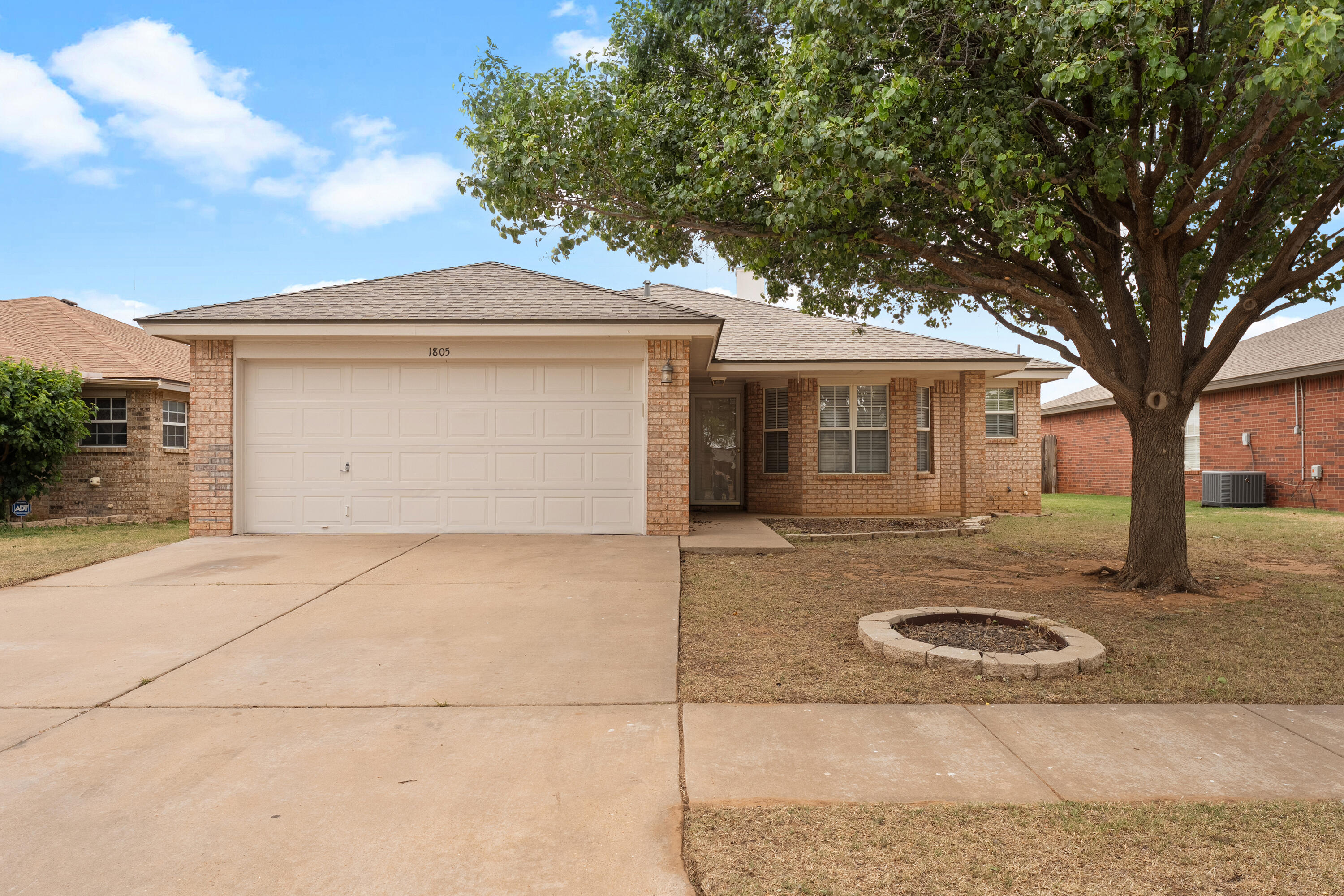 1805 75th Street Lubbock, TX 79423 - Photo 1 of 20 front view of a house with a yard