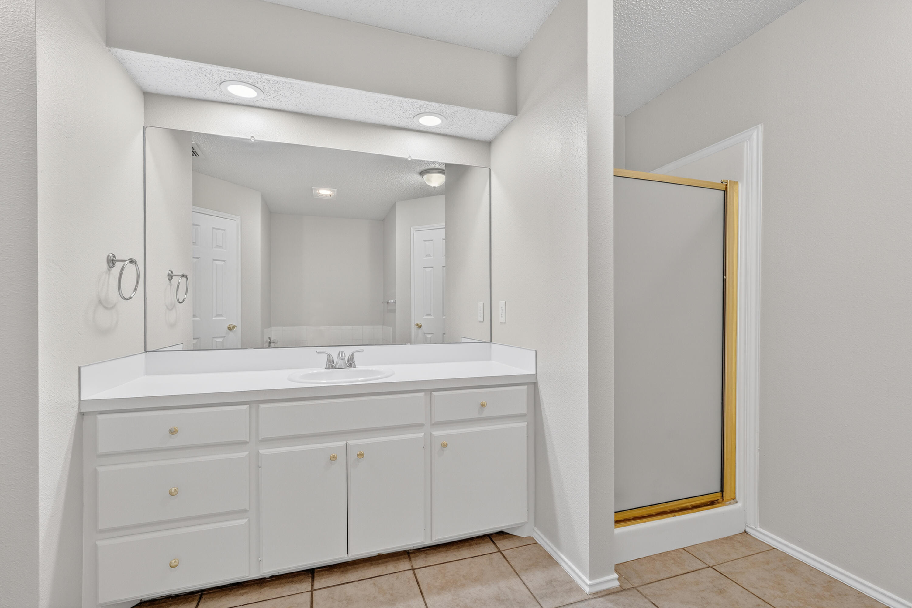 1805 75th Street Lubbock, TX 79423 - Photo 11 of 20 a bathroom with a double vanity sink and mirror