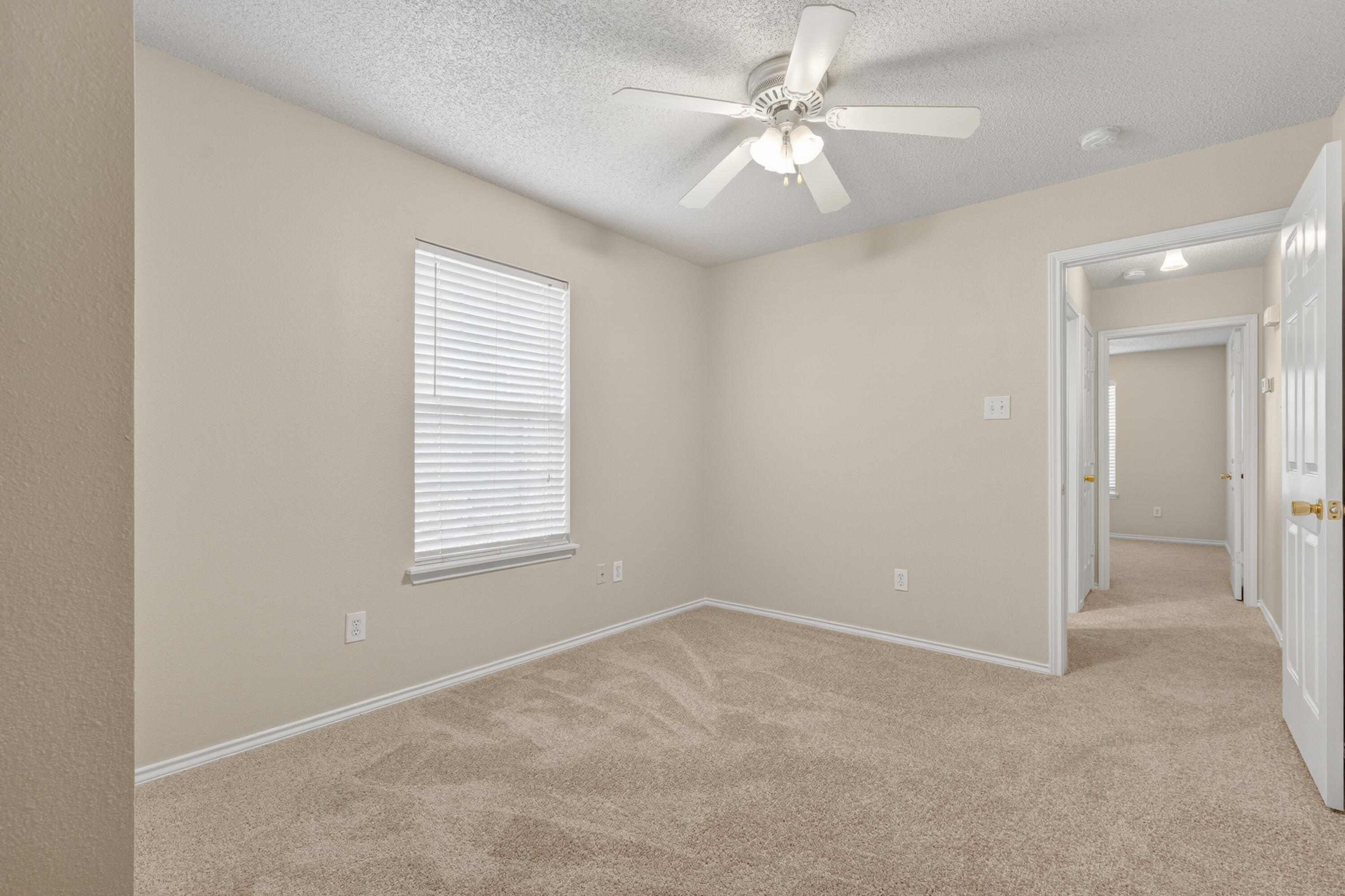 1805 75th Street Lubbock, TX 79423 - Photo 16 of 20 an empty room with windows and fan