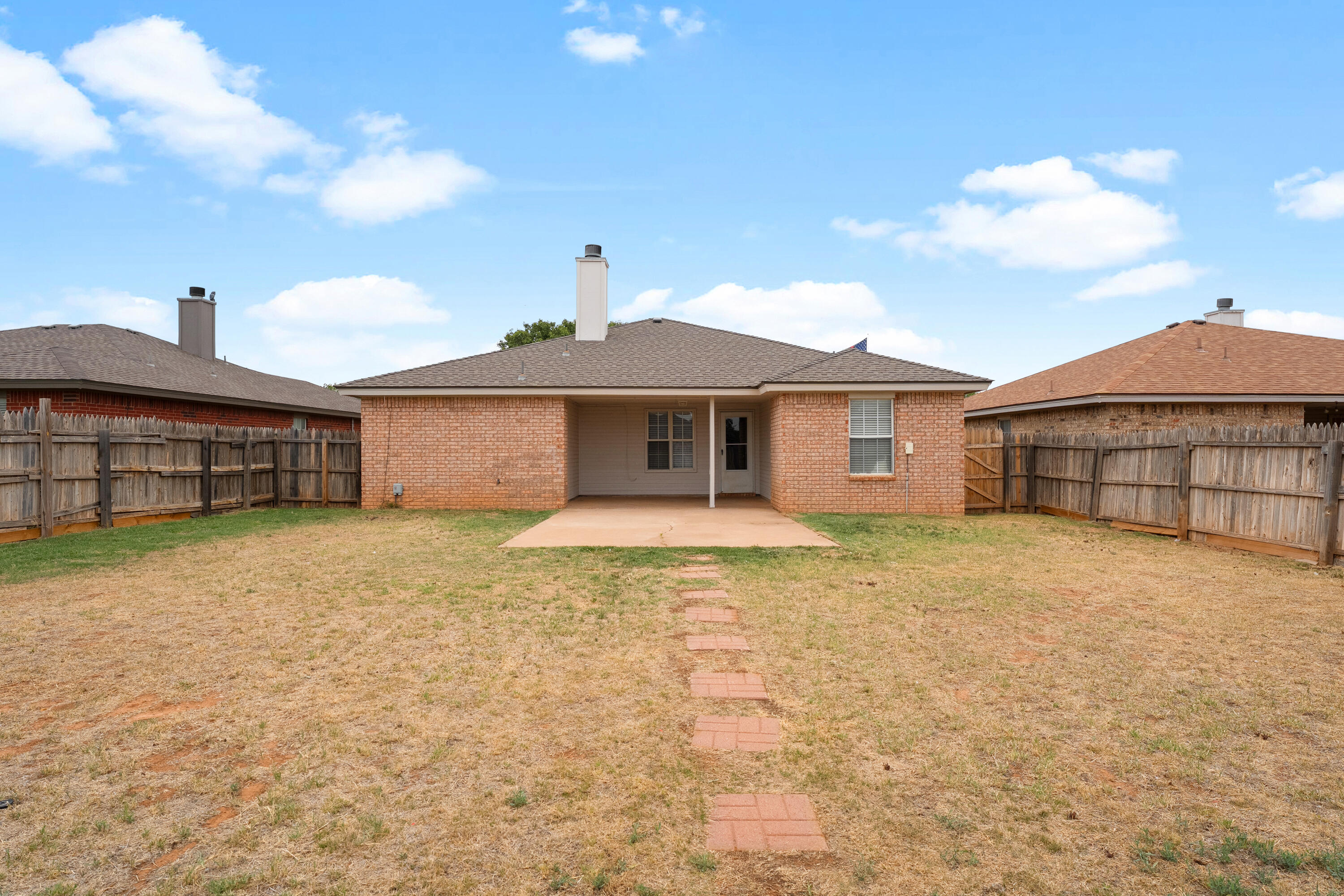 1805 75th Street Lubbock, TX 79423 - Photo 20 of 20 a front view of a house with a yard and garage