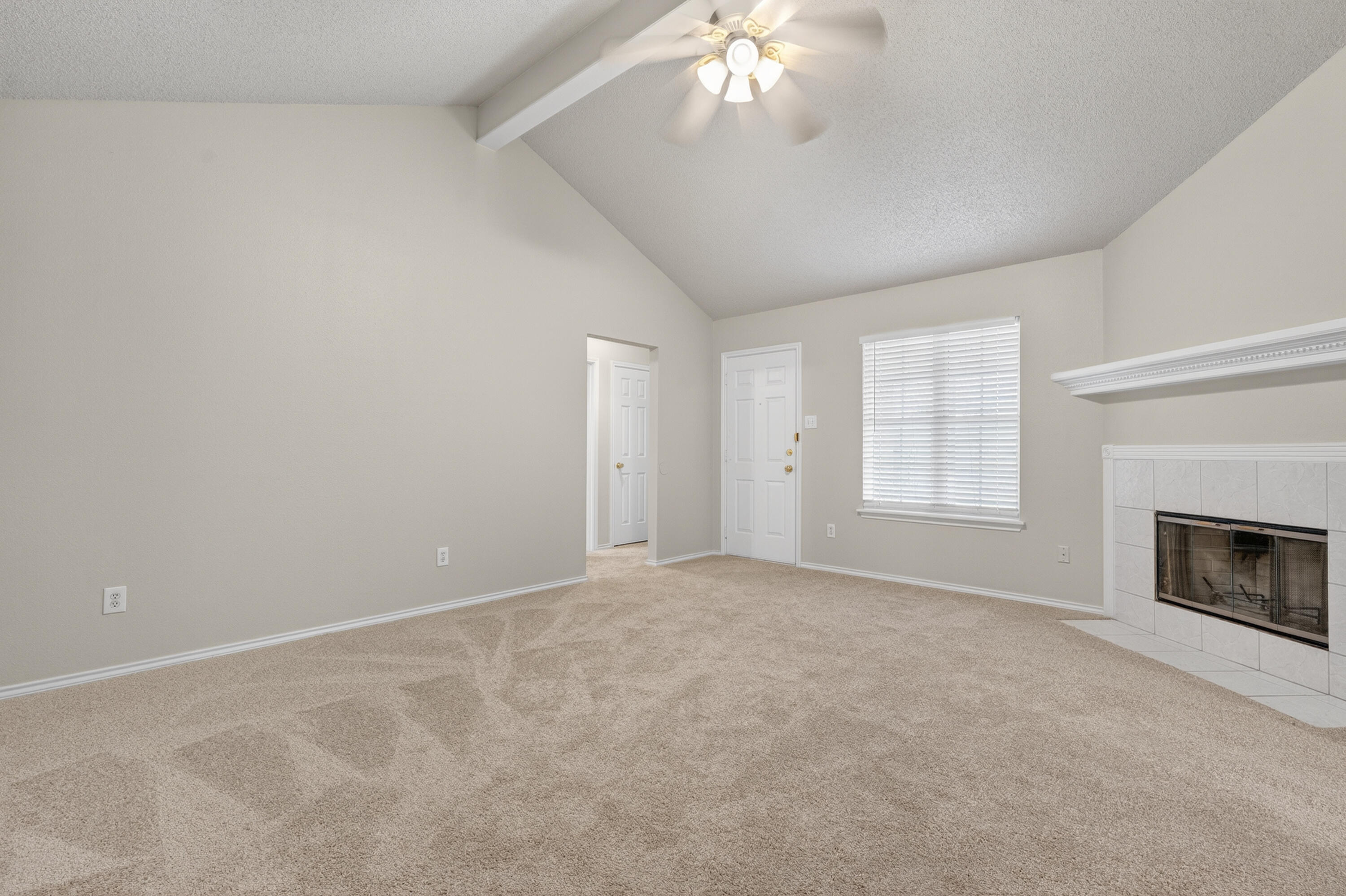 1805 75th Street Lubbock, TX 79423 - Photo 2 of 20 an empty room with windows and fireplace