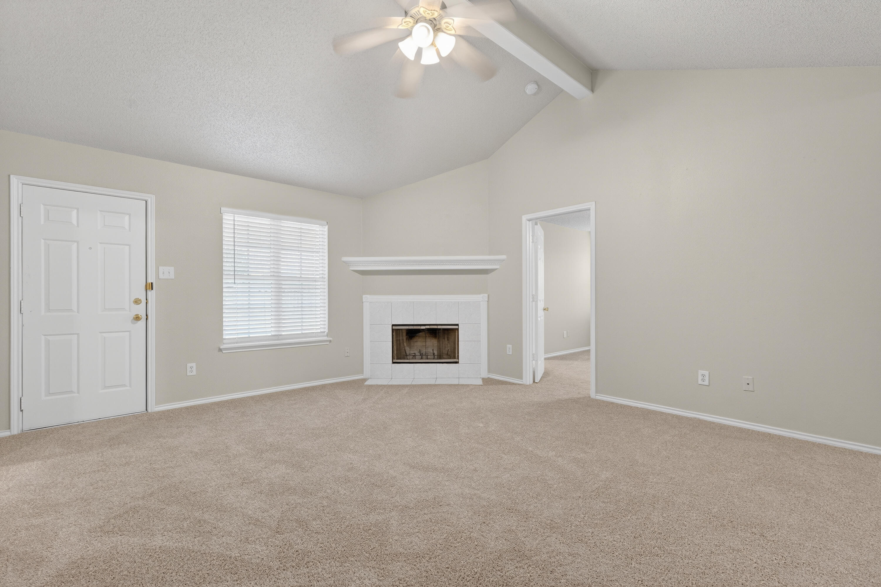 1805 75th Street Lubbock, TX 79423 - Photo 3 of 20 a view of an empty room with a fireplace and a window