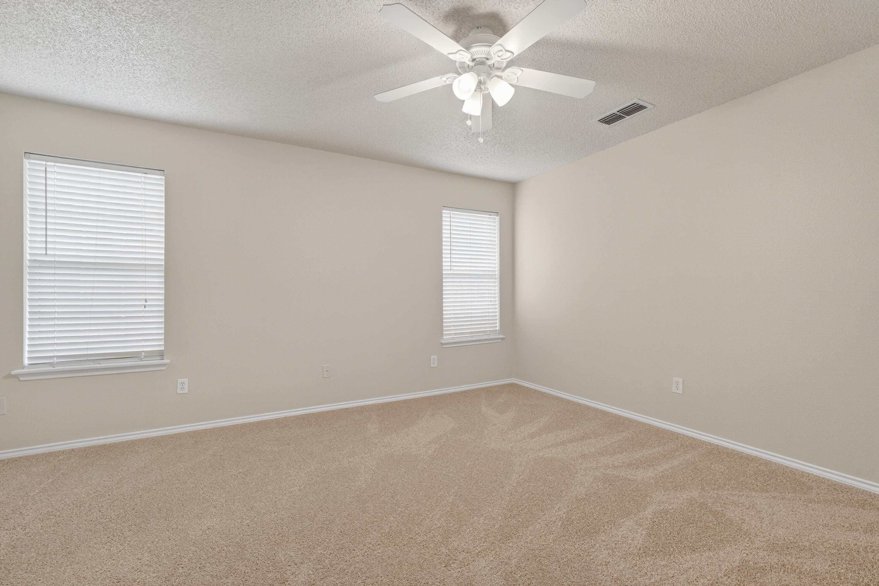 1805 75th Street Lubbock, TX 79423 - Photo 8 of 20 an empty room with a window and a fan