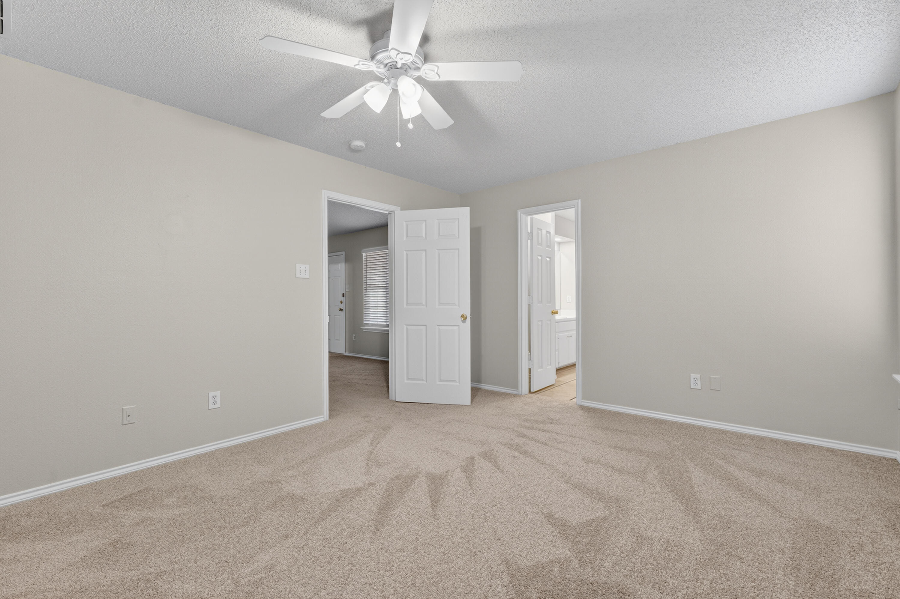 1805 75th Street Lubbock, TX 79423 - Photo 9 of 20 a view of an empty room with a ceiling fan