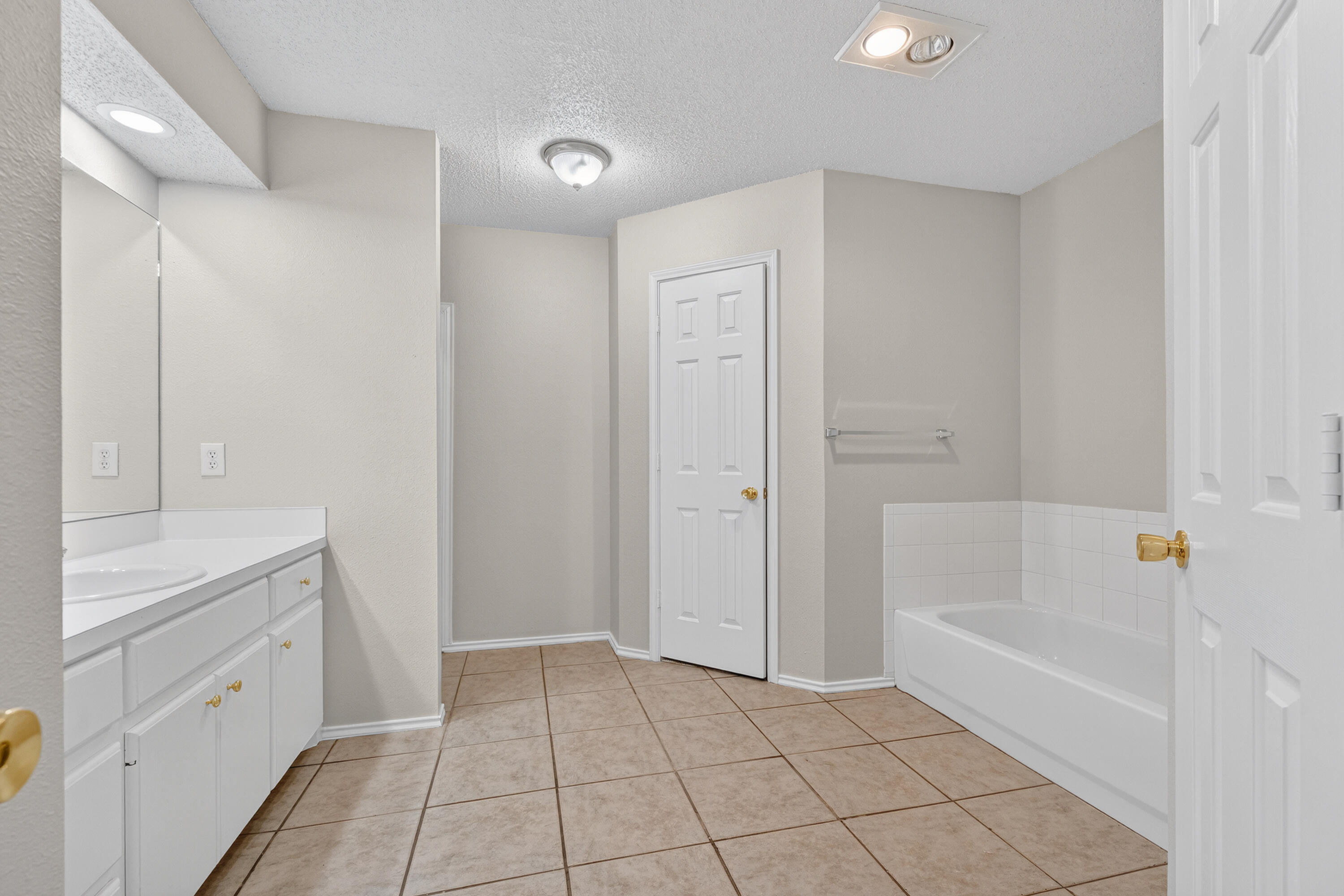 1805 75th Street Lubbock, TX 79423 - Photo 10 of 20 a bathroom with a tub shower vanity and a sink