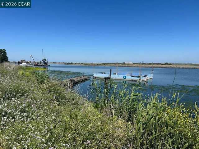 a view of a lake with houses in back