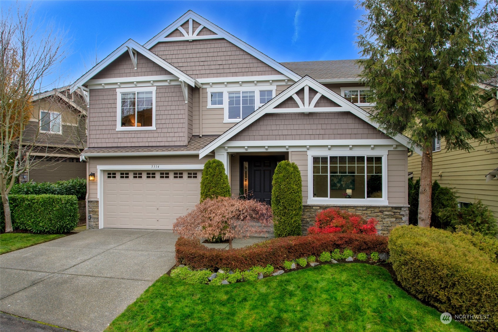 5314 Northeast 17th Place Renton, WA 98059 - Photo 1 of 40 a front view of a house with a garden and plants