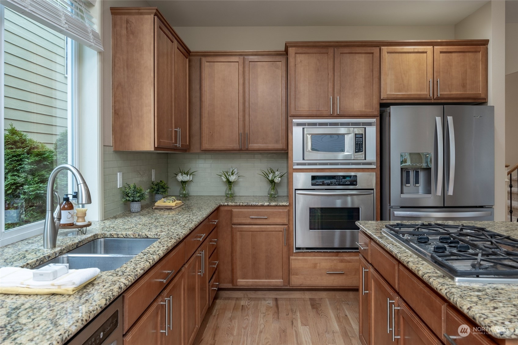 5314 Northeast 17th Place Renton, WA 98059 - Photo 11 of 40 a kitchen with granite countertop a stove sink and cabinets