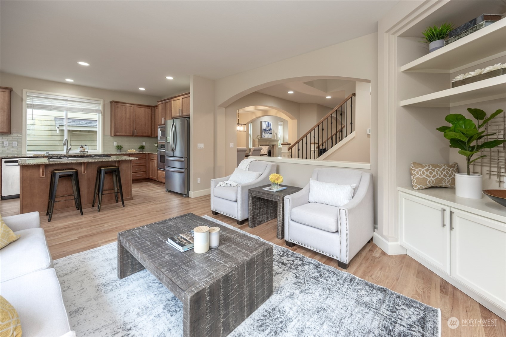 5314 Northeast 17th Place Renton, WA 98059 - Photo 9 of 40 a living room with furniture a wooden floor and kitchen view