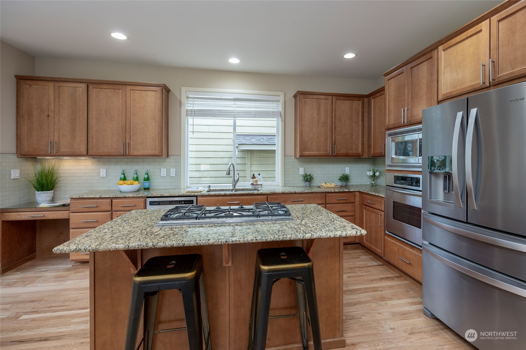 5314 Northeast 17th Place Renton, WA 98059 - Photo 10 of 40 a kitchen with stainless steel appliances granite countertop wooden cabinets a stove a sink and a refrigerator