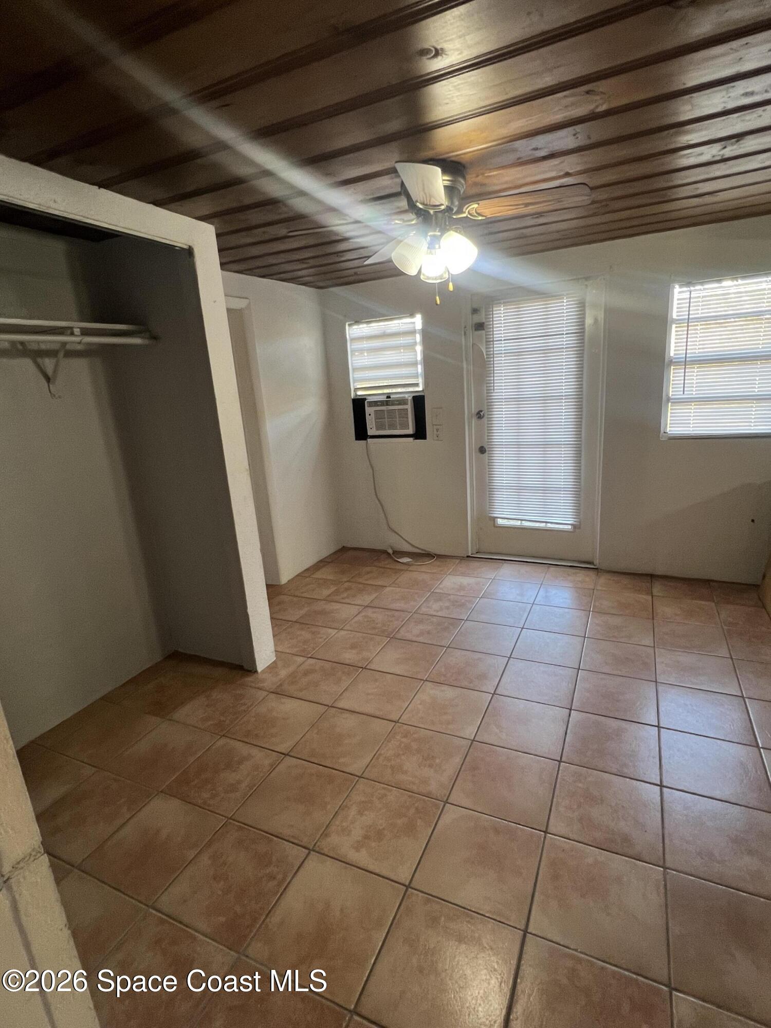 441 Vickers Street, Unit A Melbourne, FL 32935 - Photo 17 of 19 a view of a livingroom with an empty space and a window