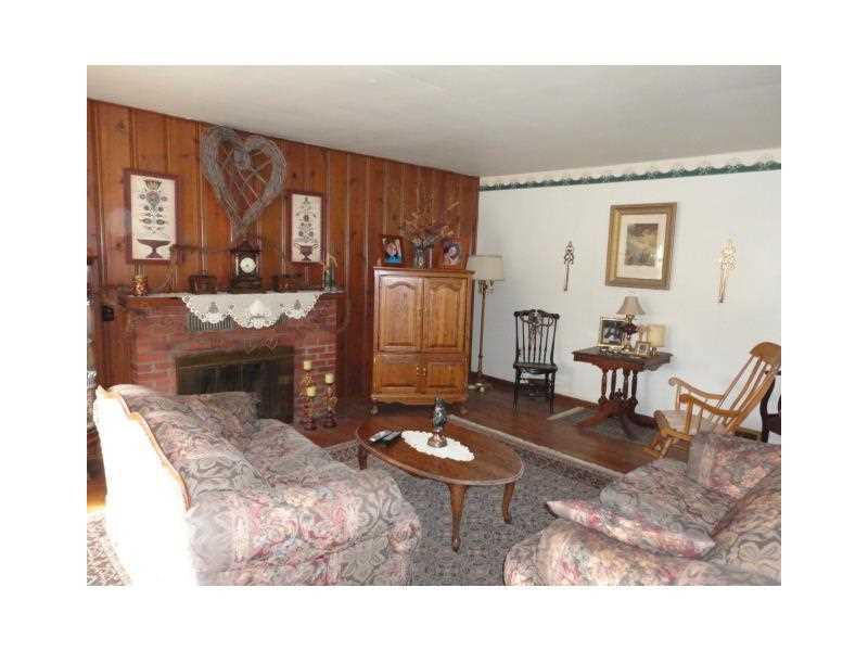 1848 Zehnder Road Economy, PA 15003 - Photo 3 of 22 Living Room. Featuring a wood burning fireplace and solid pine paneling - hardwood flooring and window exposure