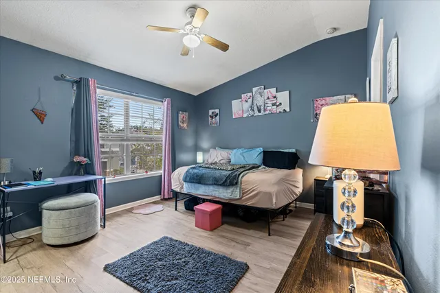 a view of walk in closet with clothes