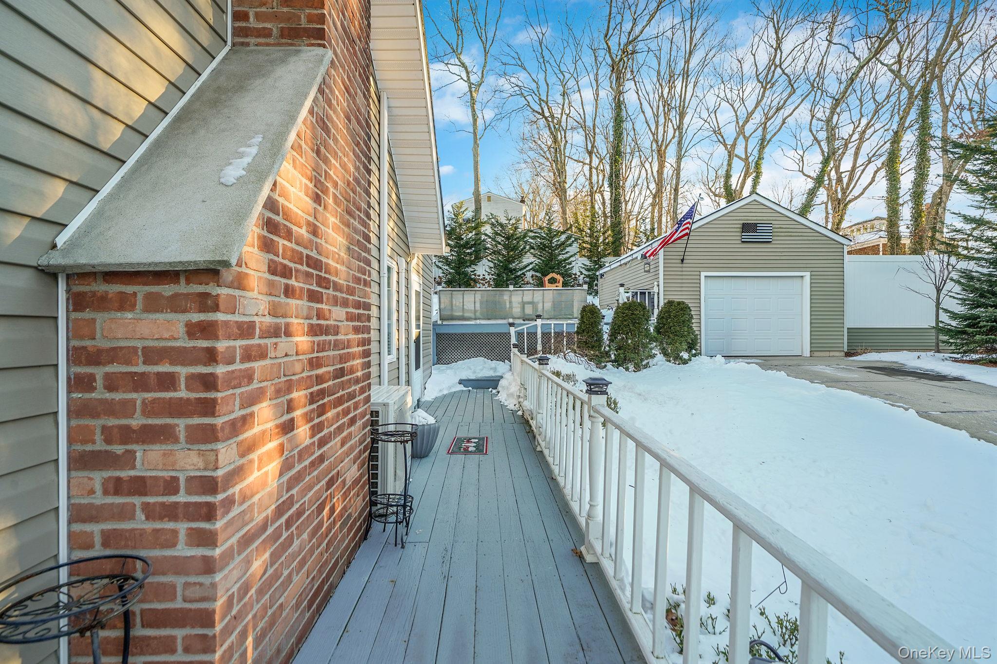 38 Hawthorne Road Rocky Point, NY 11778 - Photo 24 of 30 Snow covered deck with an outdoor structure and a garage