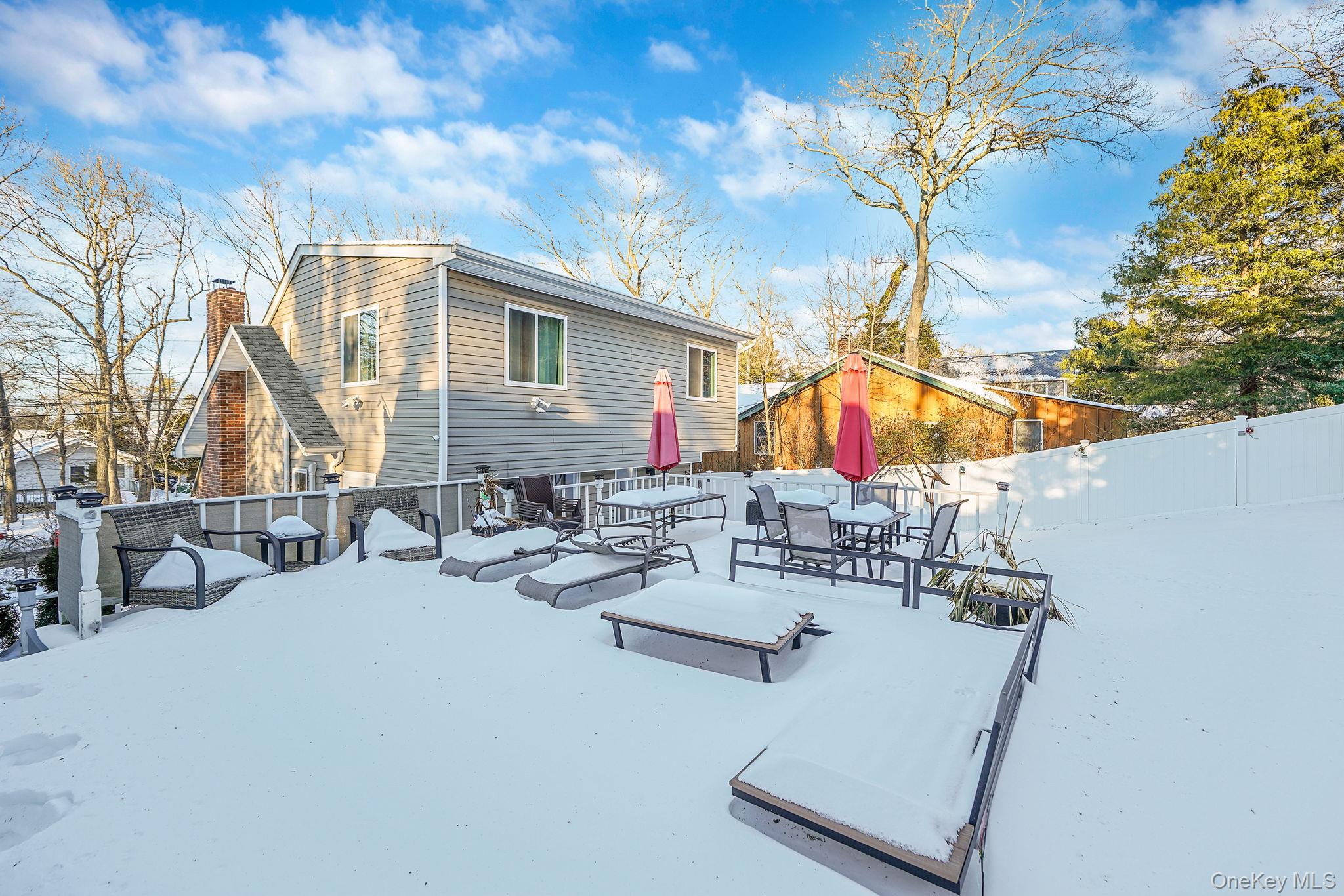 38 Hawthorne Road Rocky Point, NY 11778 - Photo 25 of 30 Back of house with a patio, a chimney, and outdoor dining space