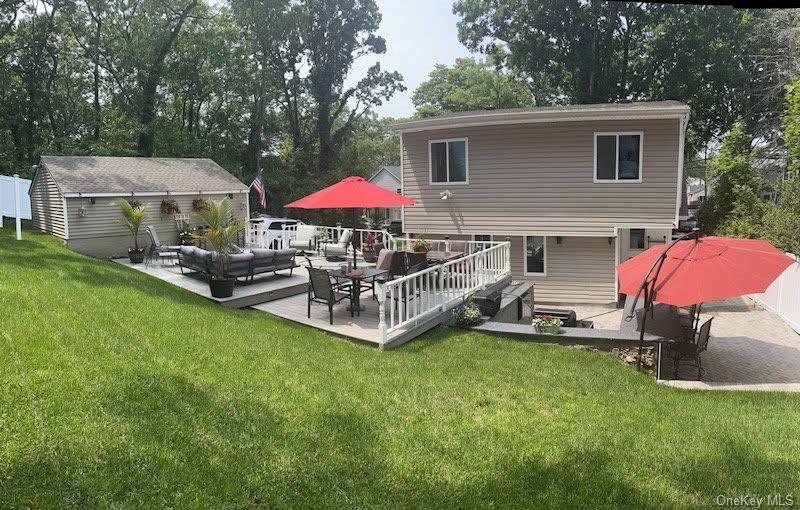 38 Hawthorne Road Rocky Point, NY 11778 - Photo 5 of 30 Rear view of property featuring outdoor seating, an outdoor structure, a deck, and view of scattered trees