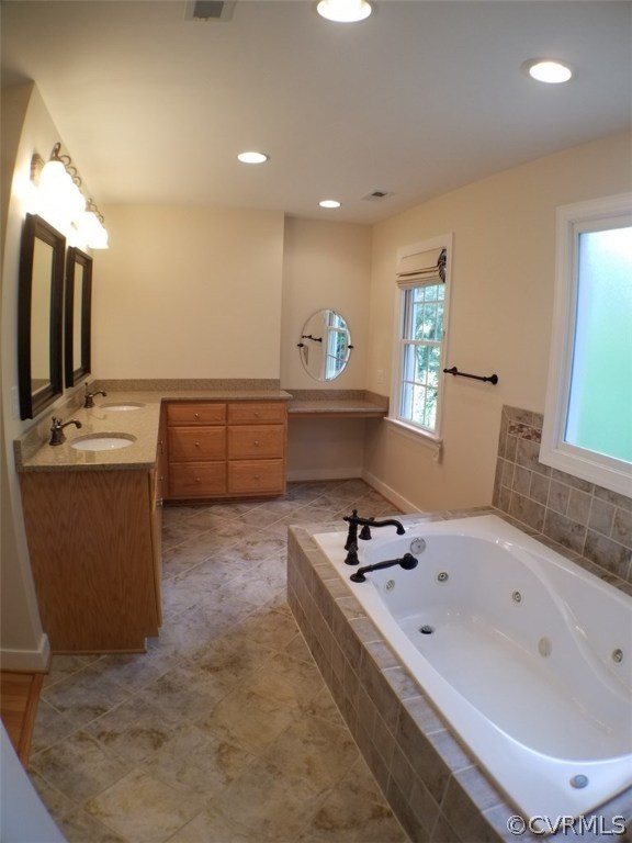 206 North Ridge Road Henrico, VA 23229 - Photo 17 of 30 a bathroom with a bathtub sink and mirror