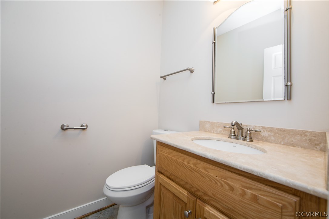 206 North Ridge Road Henrico, VA 23229 - Photo 19 of 30 a bathroom with a granite countertop toilet sink and mirror
