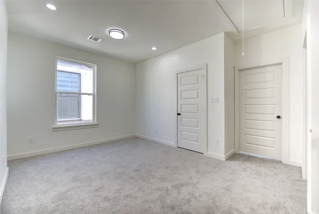 an empty room with windows and closet
