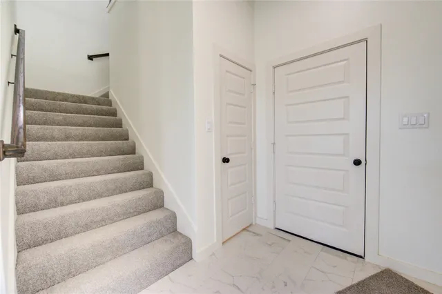 a view of staircase with white walls