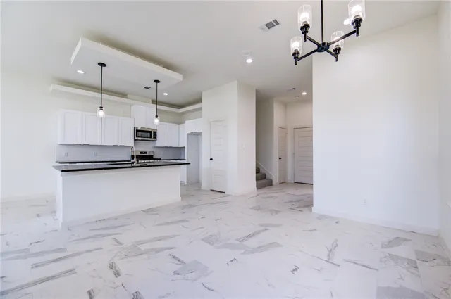 a view of kitchen with refrigerator and window