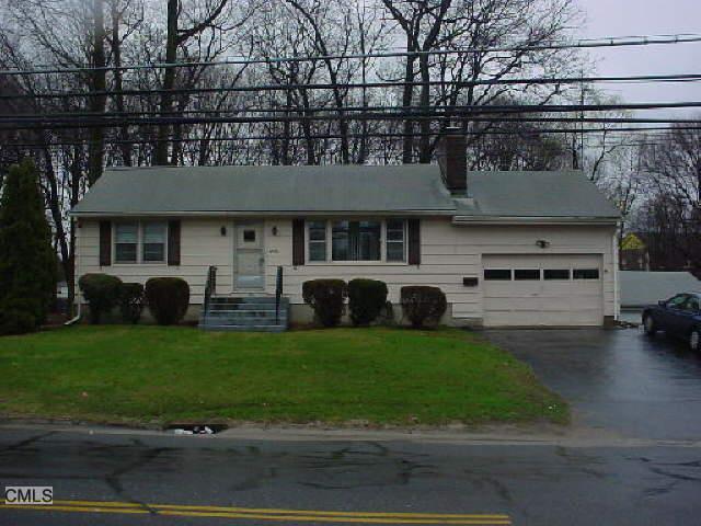 3825 Old Town Road Bridgeport, CT 06606 - Photo 1 of 1 a front view of a house with a garden and trees