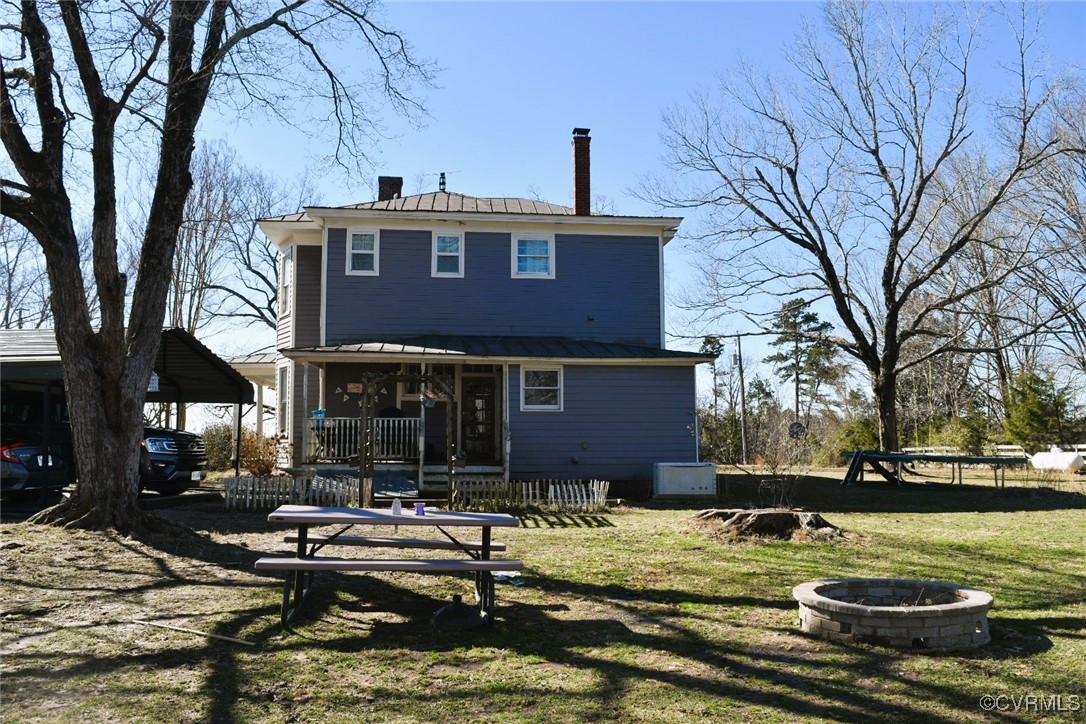 303 West Ontario Road Keysville, VA 23947 - Photo 39 of 44 Back of house with an outdoor fire pit, a lawn, a