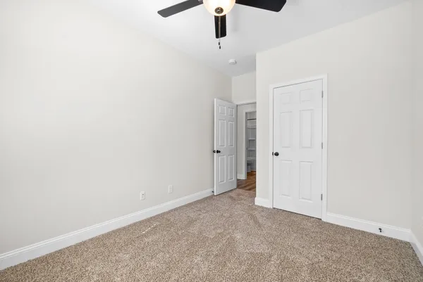 an empty room with a ceiling fan