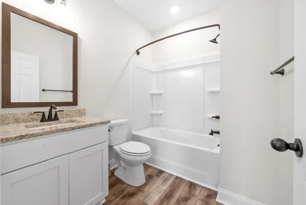 a bathroom with a sink toilet a shower and a mirror