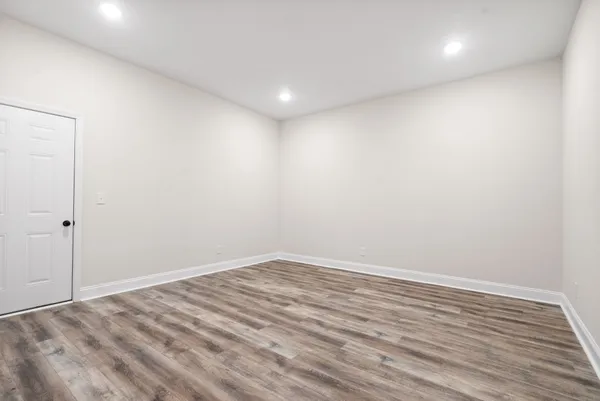 a view of room with wooden floor