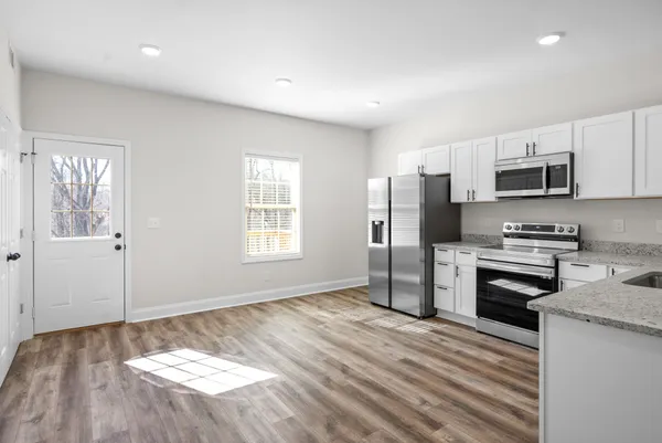 a kitchen with kitchen island a stove a sink and a refrigerator