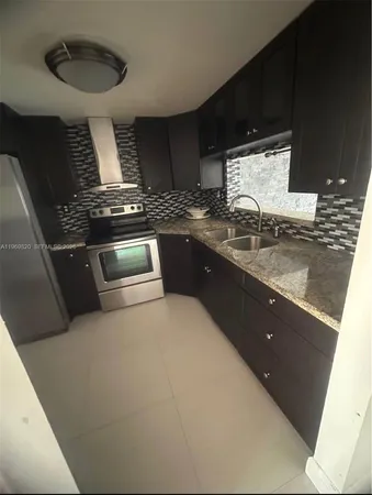 a bathroom with a granite countertop sink a large mirror and vanity
