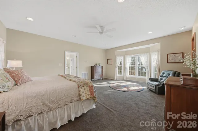 a spacious bedroom with a bed and furniture