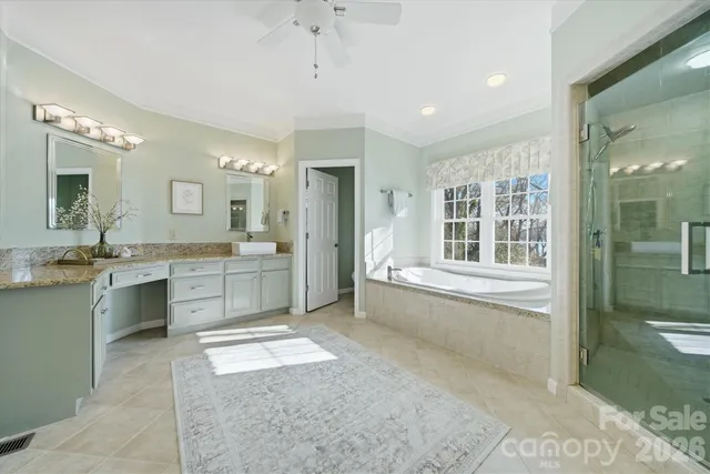 a bathroom with a tub a sink shower and mirror