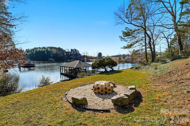a lake view with boat and palm trees
